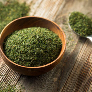 Dried green organic dill spice in a bowl