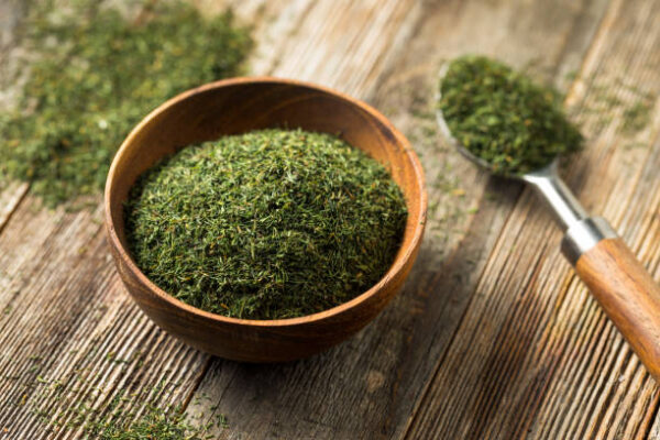 Dried green organic dill spice in a bowl