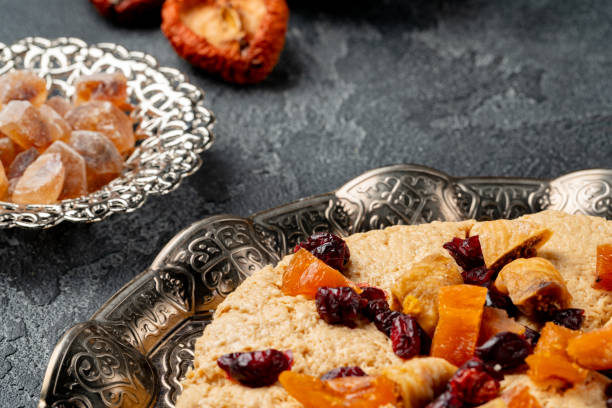 Halva with dried fruits on arabic dishware close up