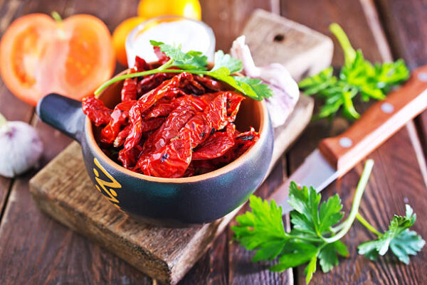 Dry tomato in bowl and on a table