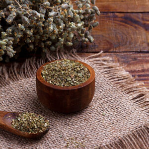 Bunch of organic dry oregano on old wooden background