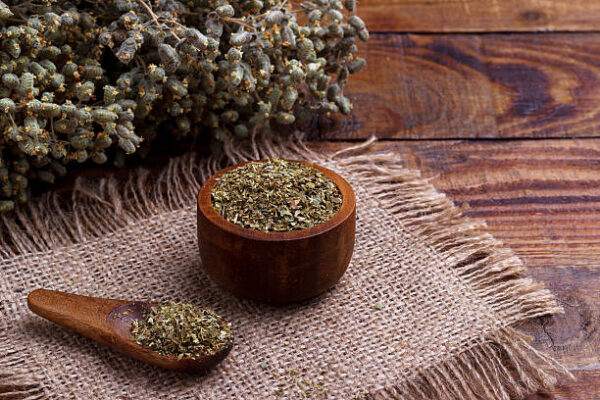 Bunch of organic dry oregano on old wooden background