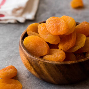 Dried apricots in wooden bowl. organic food.